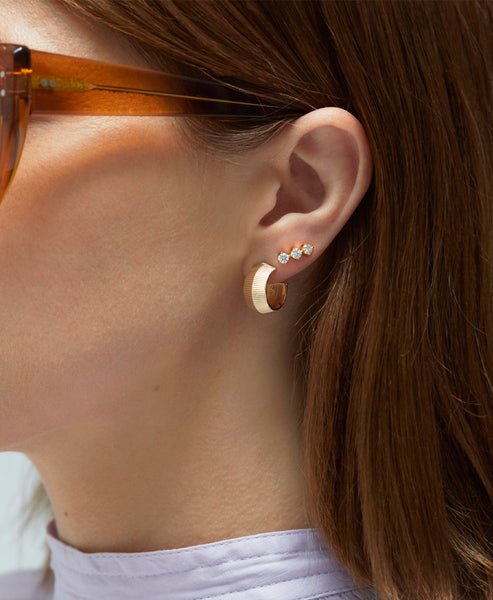 An elegant woman wearing a pear-shaped diamond ring.